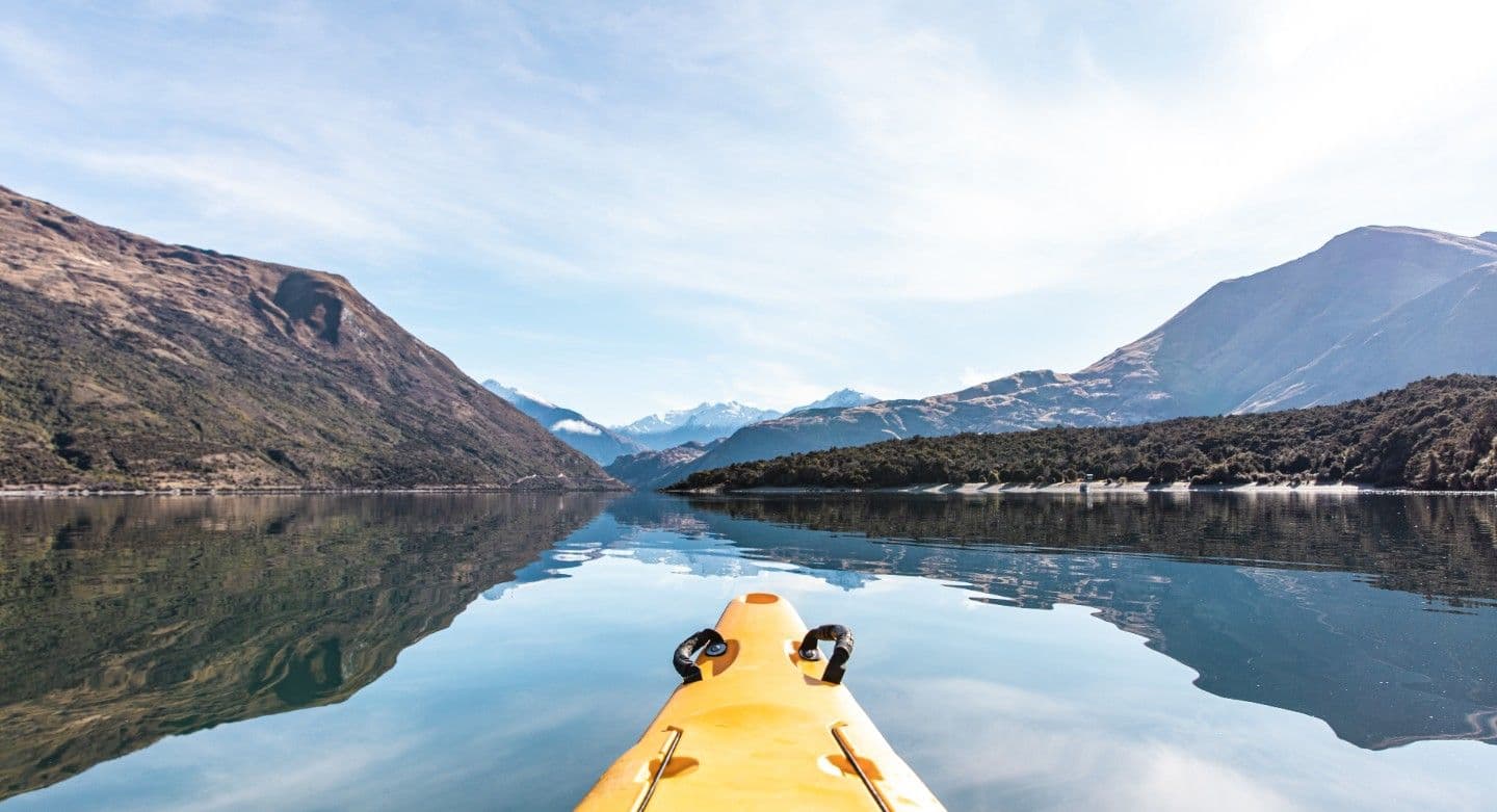 kayak on lake with mountains in background