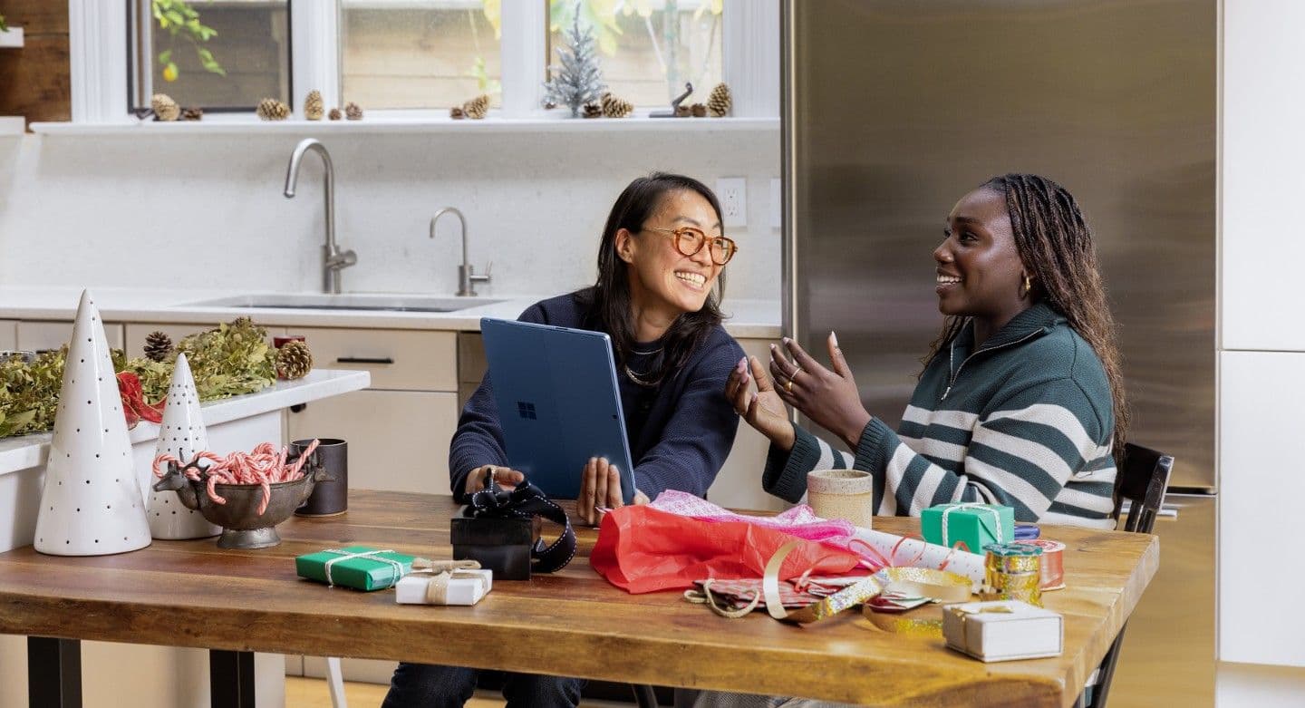 two individuals sitting at desk talking