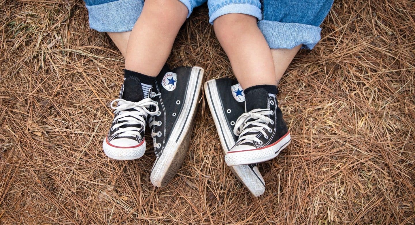 crossed legs with shoes mirrored down the middle. 